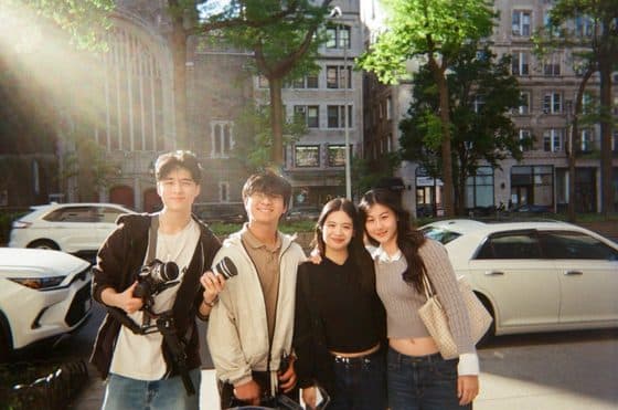 Friends with cameras on a sunny street