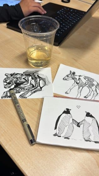 Ink sketches of animals on a desk