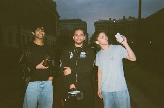 Friends outside on a campus street at night