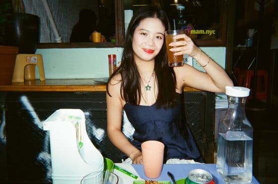 A portrait at a street-side table